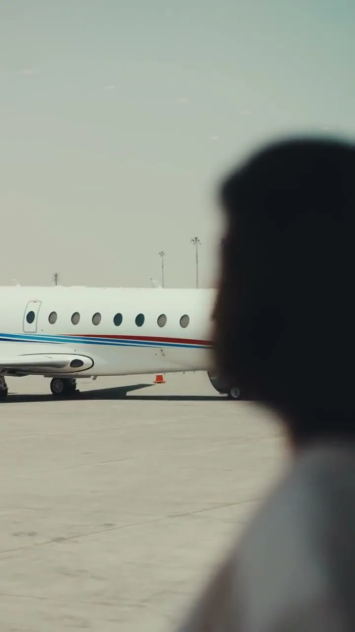 Film: a traveller watching the Gulfstream G200 on the ramp
