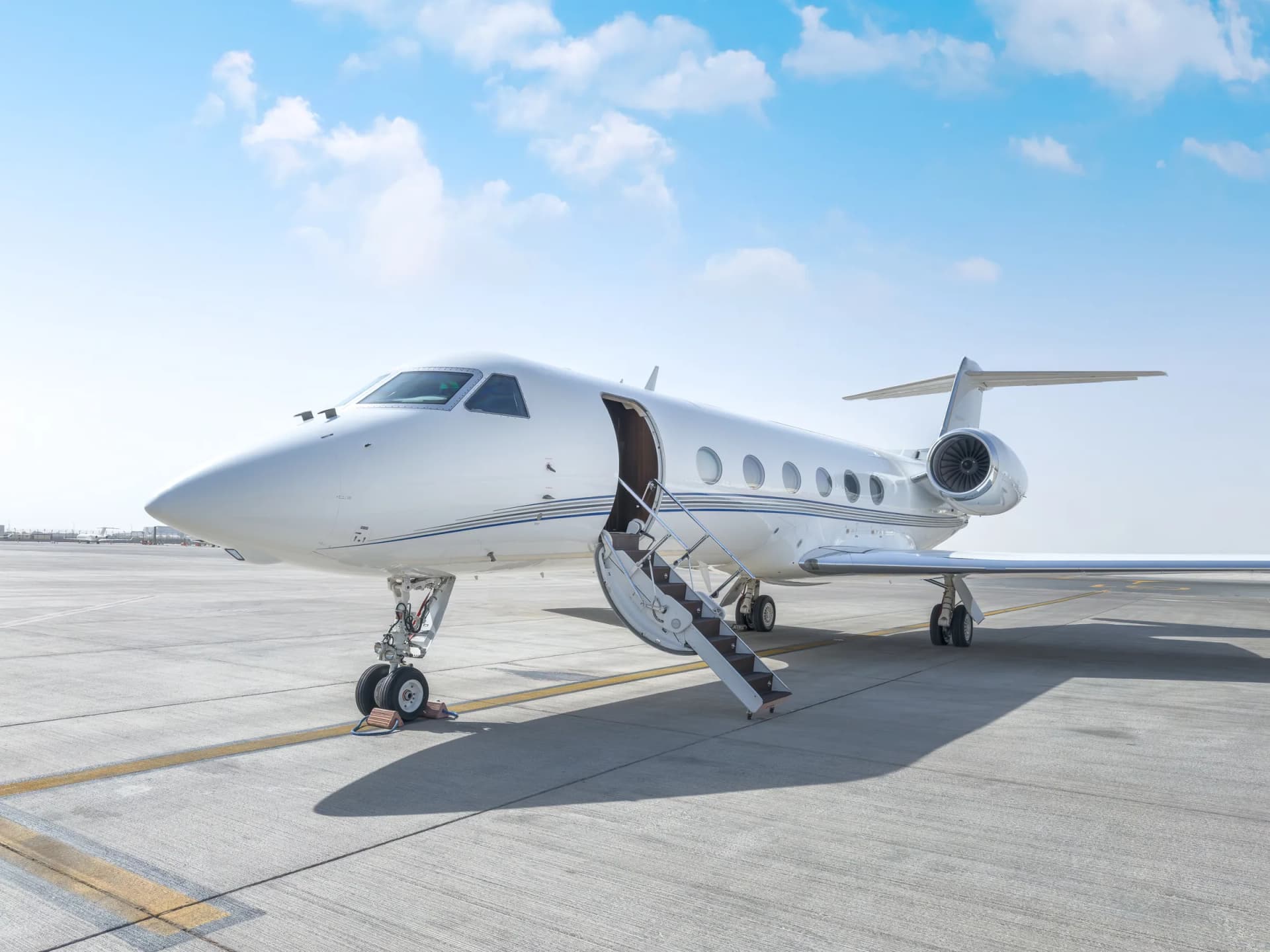 Gulfstream G450 on the ramp with its airstair down under a clear blue sky
