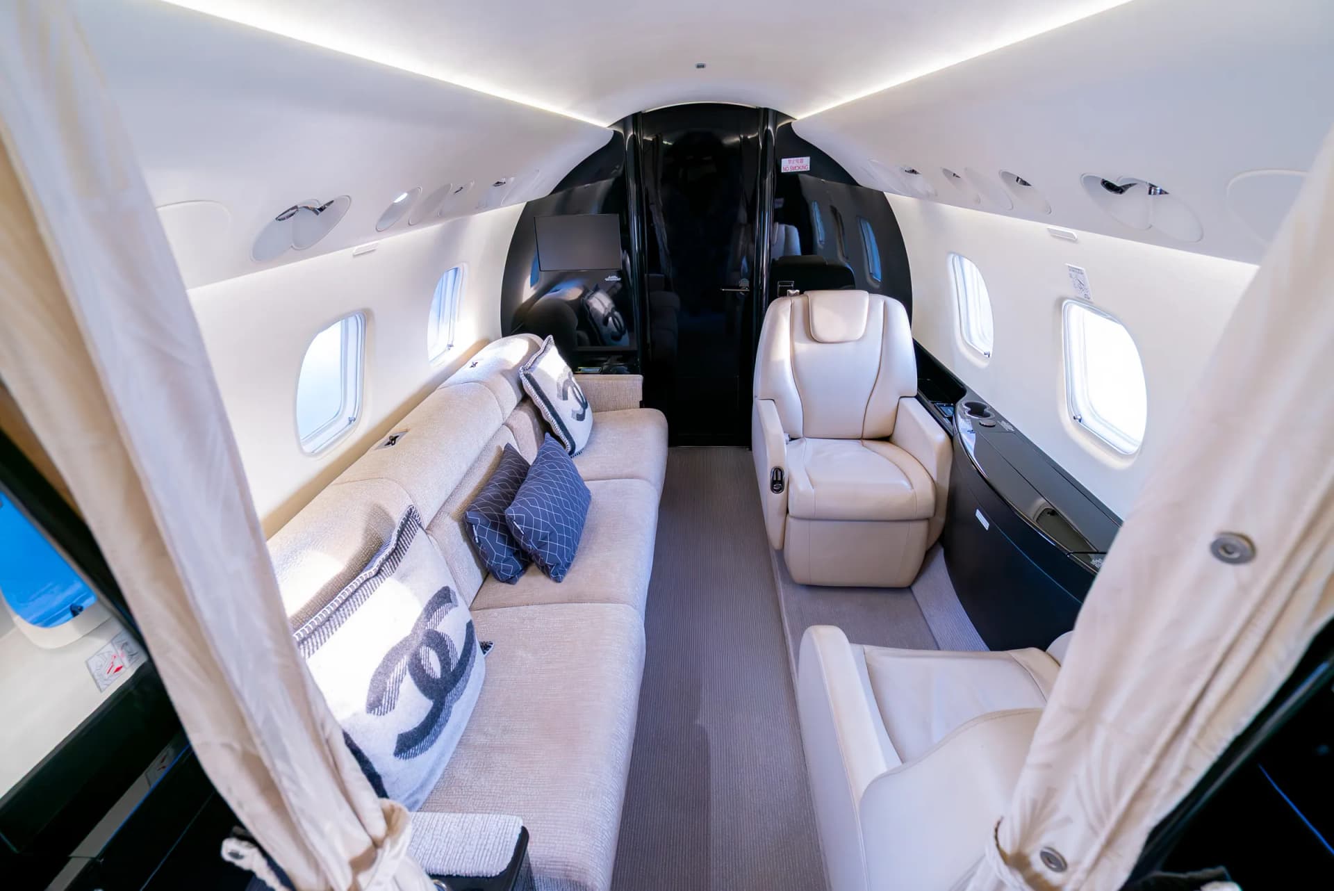 The Embraer Legacy 650 aft cabin with its divan dressed in Chanel cushions
