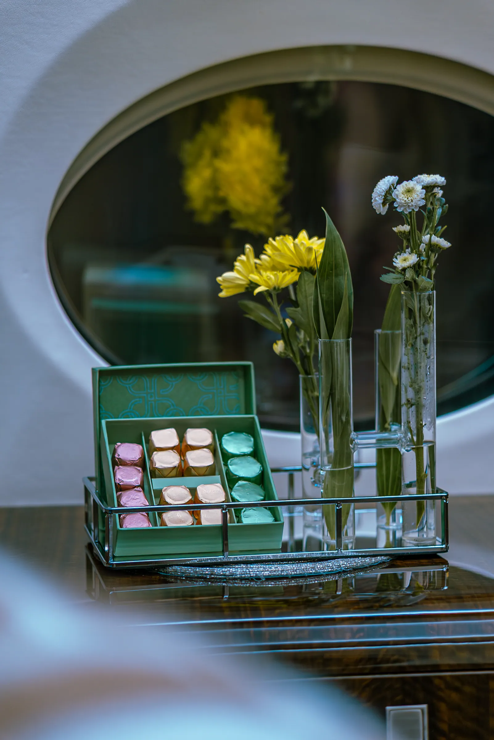 Yellow flowers and a box of macarons on the Gulfstream G450 credenza by a cabin window